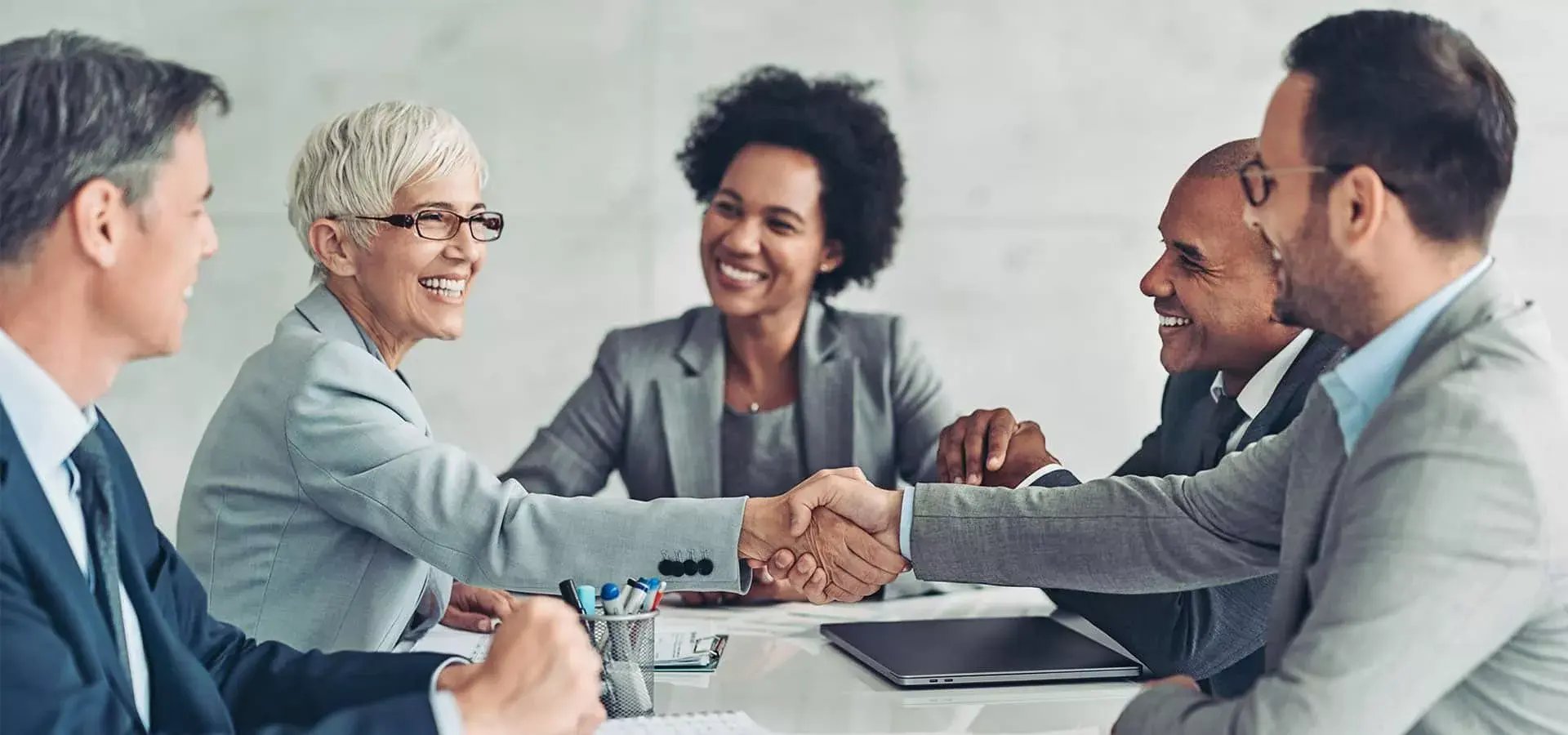 13_businesspeople-shaking-hands-during-a-meeting-1920x900-1