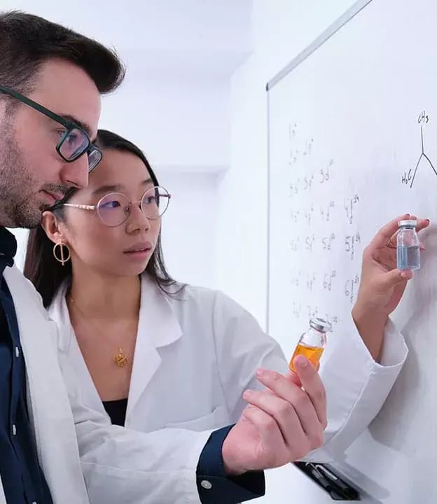 2_-Scientist-drawing-a-chemical-formulation-in-a-board-in-a-lab-624x720-1-1